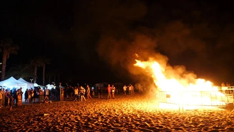 A big bonfire on the beach at night in honor of the fireworks festival Stock Footage 112262886
