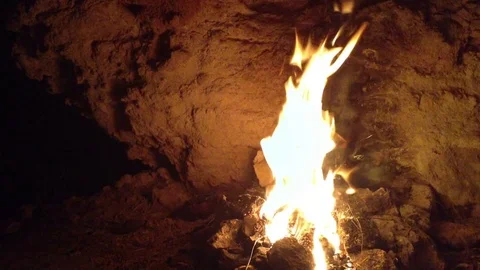 Big bonfire burning in the cave . Around view Stock Footage 73679040