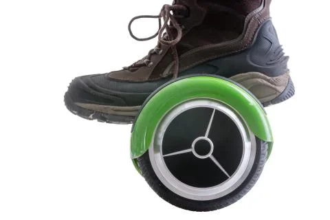 Big boot riding a hover board Stock Photos