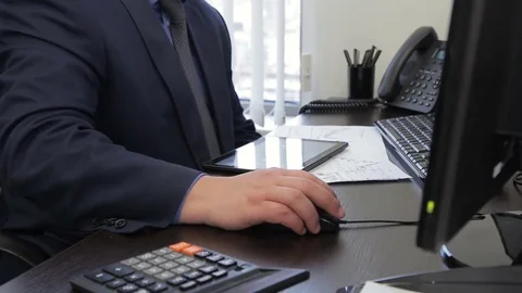 The big boss in expensive suit writes a report on his computer in the office Video stock 85373544