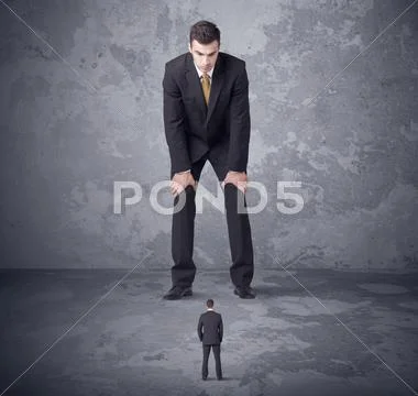 Big boss looking at tiny coworker Stock Photos