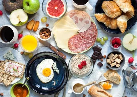 Big breakfast on the white rustic table. Stock Photos