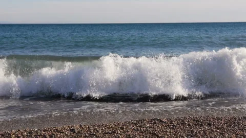 Big breaking sea wave on a beach in sunny day slow motion Stock Footage 104988289