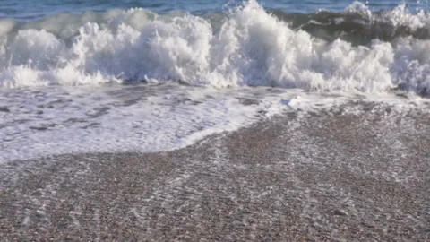 Big breaking sea wave on a beach in sunny day slow motion Stock Footage 104990889
