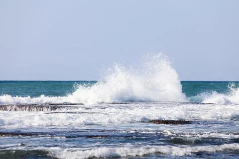 The big breaking waves during a strom at the beautiful summer sea shore Stock Photos