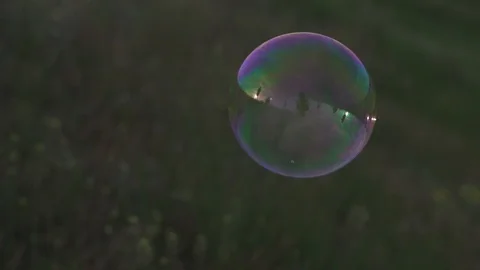 Big bubble fly over the grass and collapse. Nature reserve. Eco-friendly Stock Footage 103839044