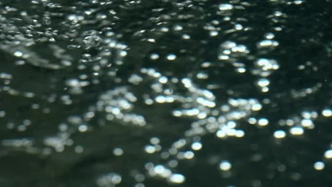 A big bubble ring bursting and spreading bubbles over a black background Stock Footage 274680943