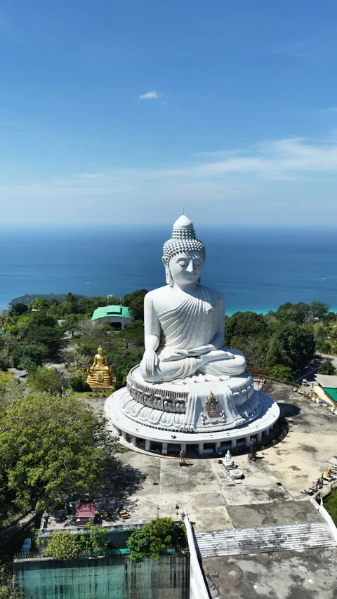 Big Buddha of Phuket above forested hillside and Andaman Sea, aerial Stock Footage 345267628