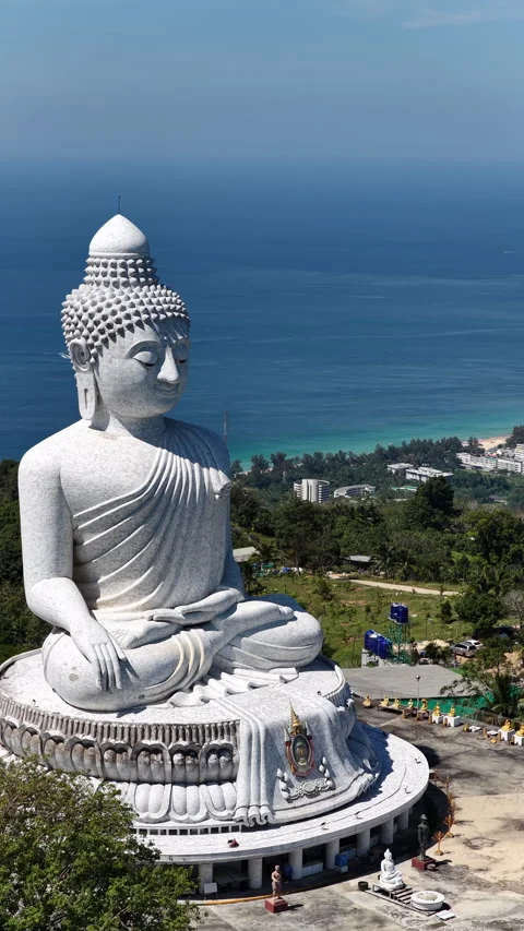 Big Buddha of Phuket above lush forest and turquoise Andaman Sea Stock Footage 345269161