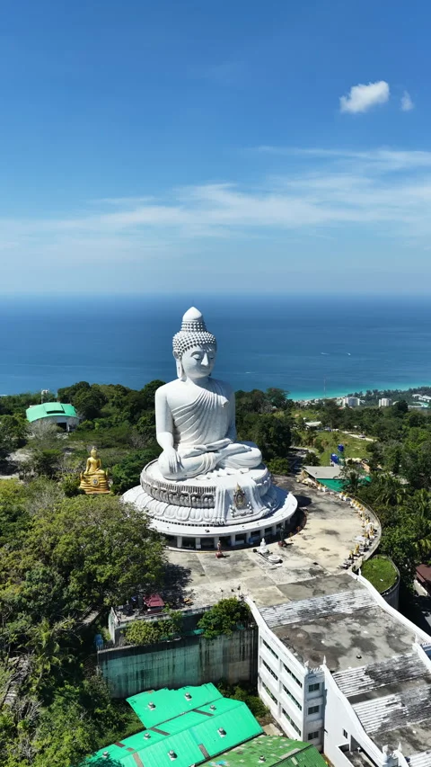 Big Buddha of Phuket facing blue Andaman Sea above tropical hillside Stock Footage 345264666