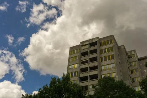 A big building below a cloudy summer sky Stock Photos
