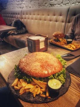 Big burger on the table Stock Photos