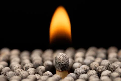 Big burning match between other burnet and put out matches Stock Photos