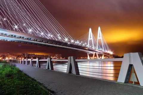 Big cable-stayed bridge over the river at night with colorful bright lighting Stock Photos