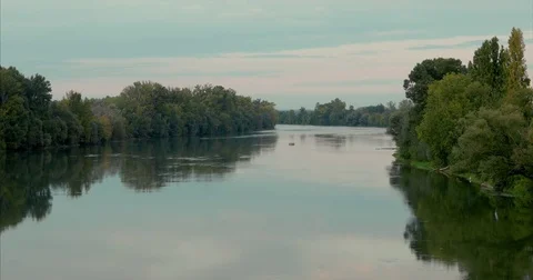 Big calm river reflecting sky and trees Stock Footage 81358019