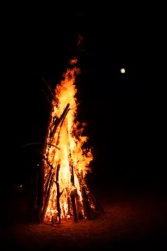 Big campfire with moon in the background Stock Photos