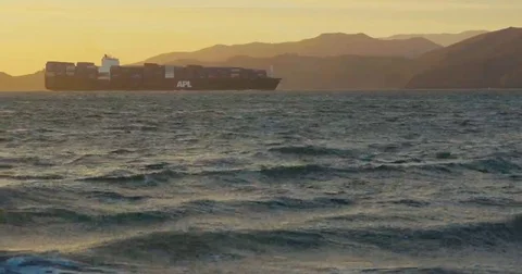 Big cargo ship with containers entering harbor by the sunset at the sea Video stock 69260891