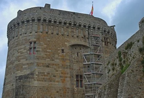 Big central stone tower with flag on top at Dinan fortress, France Stock Photos