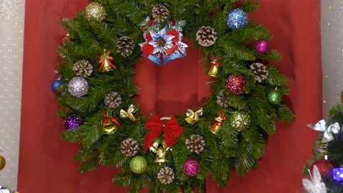 Big Christmas wreath between two Christmas trees Stock Footage 146760468