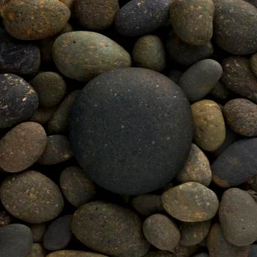 Big circle stone on small pebbles, group of rocks in round shape Stock Photos