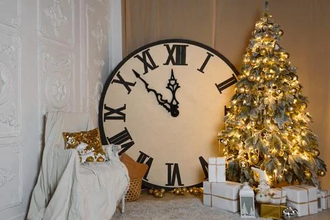 Big Clock Shows 12. New Year's Eve. Snow-covered Christmas Tree with Golden T Stock Photos
