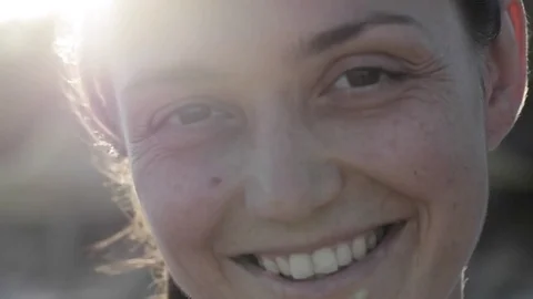 Big close up of young woman's face outdoor with beautiful natural light Stock Footage 73630317