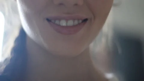 Big close up of young woman's face smiling. Fashionable knitted sweater of milky Stock Footage 74062415