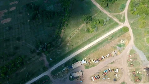 A big cloud shadows the road and the parked old cars on the edge of a village Stock Footage 119498597