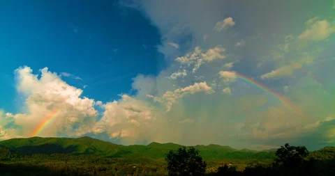 Big clouds and rainbow on sky and mountains Time-lapse. Stock Footage 101767481