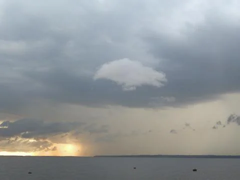 Big clouds over the lake Stock Photos