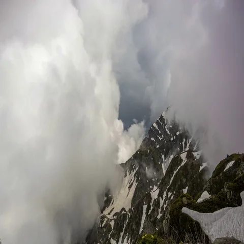 Big clouds over the snow-capped mountain peaks Stock Footage 69550524