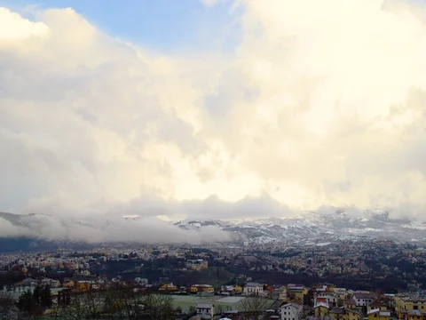 Big clouds over the village with background mountains Stock Footage 71942494