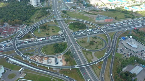 Big clover intersection at summer in shadow under clouds. Traffic in real speed. Video stock 139886822