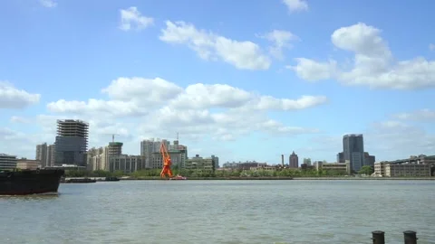 Big coal boat passing river city on a sunny day Stock Footage 164899601