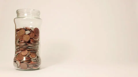 Big Coin Jar filling with Money Stock Footage