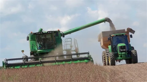 Big combine harvesting and discharging in the same time Stock Footage