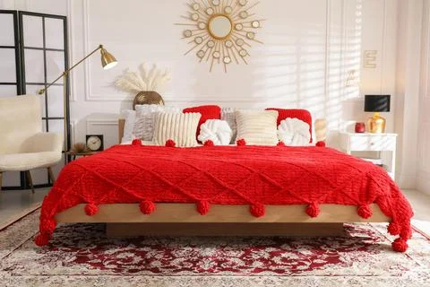 Big comfortable bed and decorative elements in room. Stylish bedroom interior Stock Photos