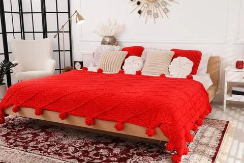 Big comfortable bed and decorative elements in room. Stylish bedroom interior Stock Photos
