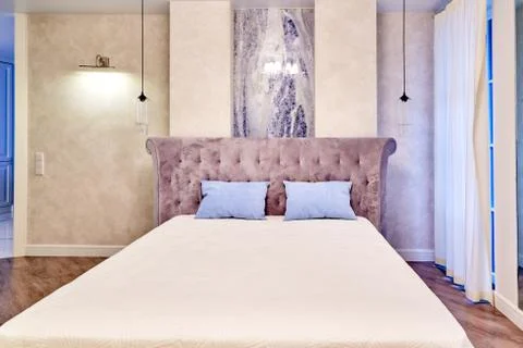 Big comfortable double bed in elegant luxary bedroom Stock Photos