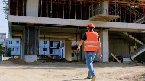 At big construction site walking foreman in a safety equipment to the Stock Footage 141183167