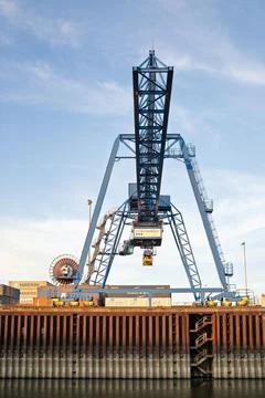 Big container crane on dock with a day with blue sky Stock Photos