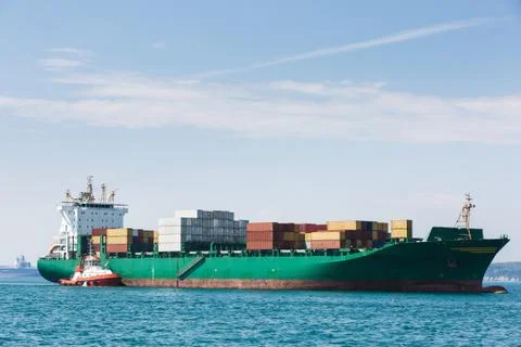 Big container ship with towboat Stock Photos
