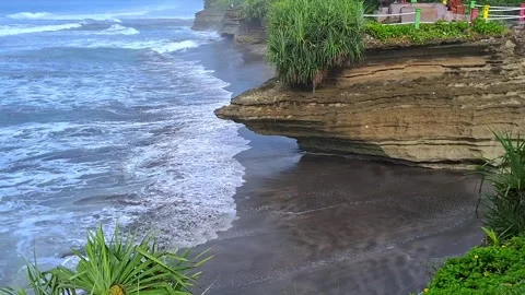 Big coral rocks in the beach with waves. Indonesian beach typical Stock Footage 307191516