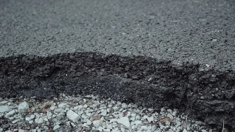 Big crack in the road surface. Plan transition from macro to medium. 스톡 동영상 113785920