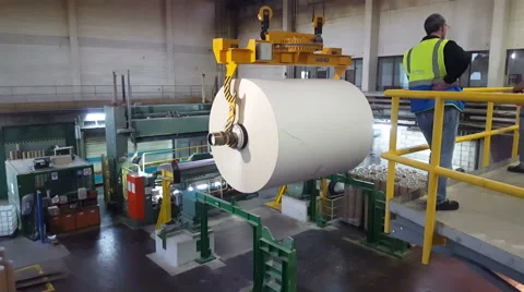 A big crane lifting a roll of paper Stock Footage 58089892