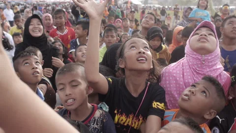 Big crowd active children trying to catch candy running and pushing each other Stock Footage 163881783