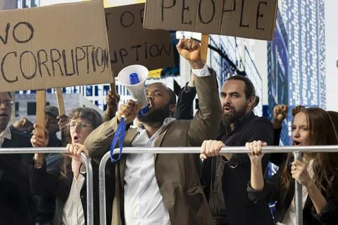 Big crowd of diverse protesters using megaphone and fighting against corruption Stock Photos