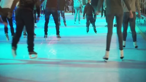 Big crowd of young people skating on the indoor ice rink with manufactured ice Stock Footage 80069162
