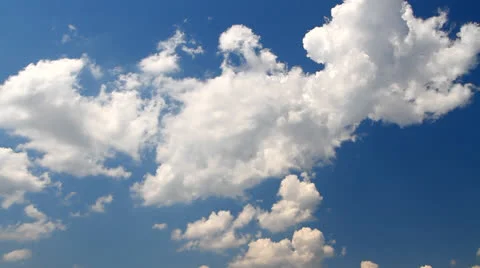Big cumulus clouds, floating on a blue sky in a strong wind Stock Footage 26638810