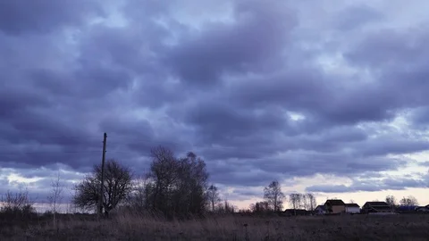 Big dark clouds lit by the rays of the sun, are floating in the blue sky, time Stock Footage 128168512